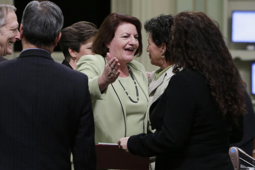 Assemblywoman Toni Atkins (D-San Diego), center, is congratulated by Assemblywoman Lorena Gonzalez (D-San Diego), right, after she was elected Assembly speaker at the Capitol in Sacramento. By a unanimous voice vote, Atkins was elected to replace Speaker John Pérez (D-Los Angeles). Perez says a transition date has not been set but that it will be before summer.