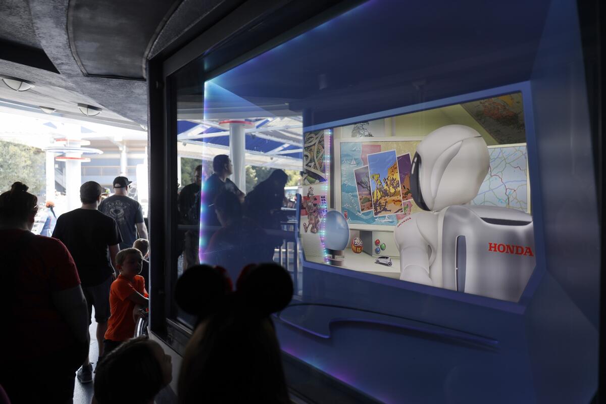 A video that plays for guests in line at Autopia shows Honda's ASIMO robot character seemingly preparing for a road trip.