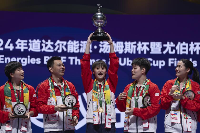 China's Chen Yu Fei holds up the Uber Cup after leading Team China 3-0 to win over Team Indonesia in the final of the Uber Cup held in Chengdu in southwestern China's Sichuan Province, Sunday, May 5, 2024. (AP Photo/Ng Han Guan)