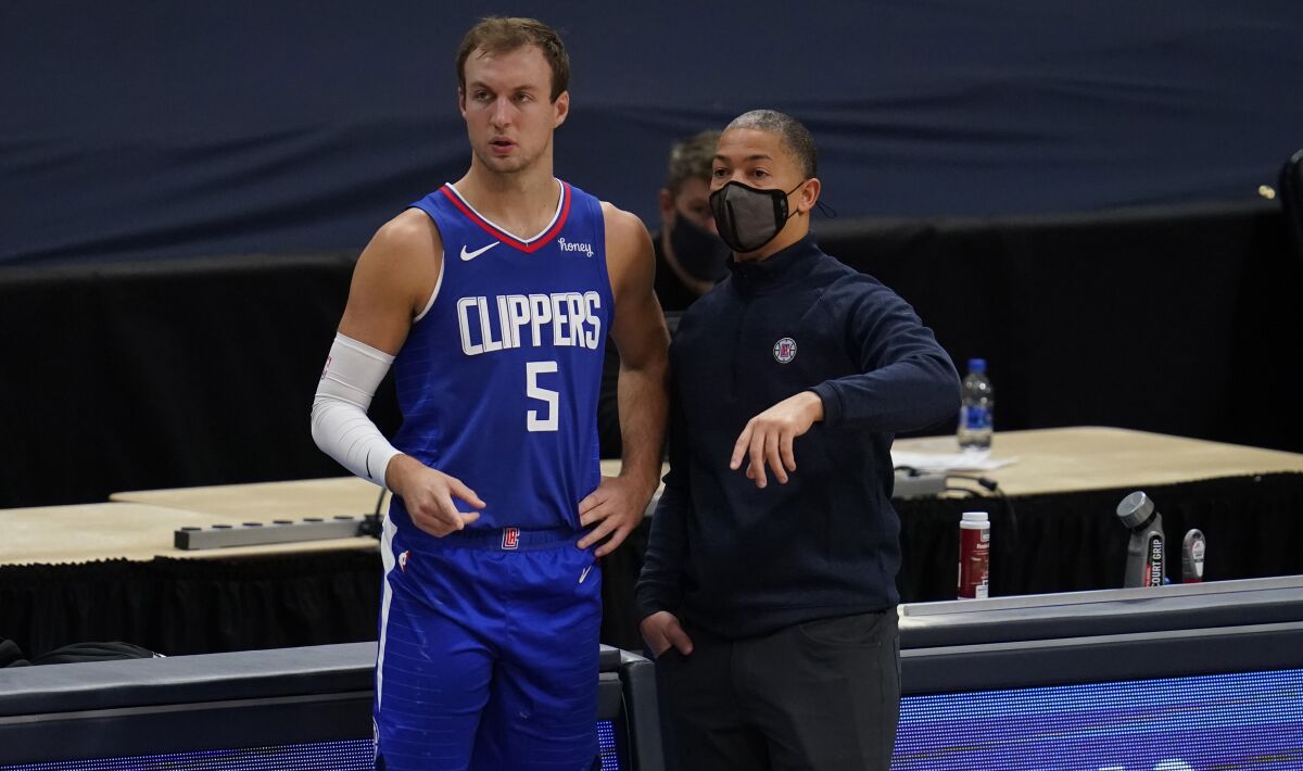Clippers guard Luke Kennard confers with coach Tyronn Lue during a game against the Nuggets.