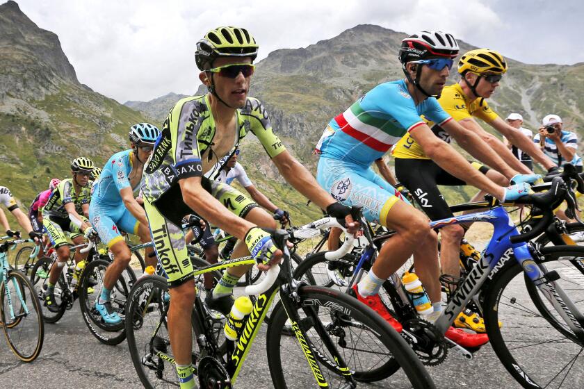 Chris Froome, wearing the overall leader's yellow jersey, stage winner Vincenzo Nibali, second right, and Poland's Rafal Majka climb side by side during the 19th stage of the Tour de France on Friday.