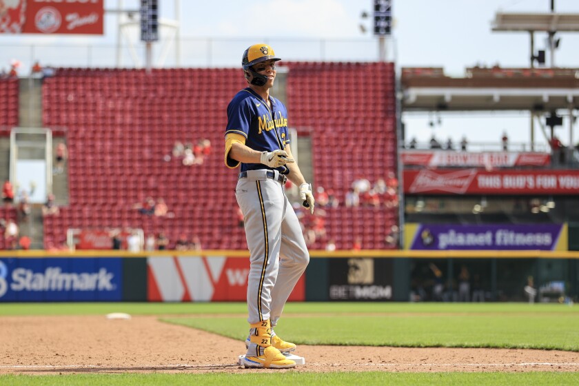 Milwaukee Brewers' Christian Yelich reacts at third base after he completed the cycle by hitting a triple during the ninth inning of a baseball game against the Cincinnati Reds in Cincinnati, Wednesday, May 11, 2022. The Reds won 14-11. (AP Photo/Aaron Doster)