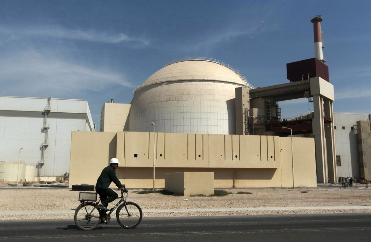 FILE - A worker rides a bicycle in front of the reactor building of the Bushehr nuclear power plant, just outside the southern city of Bushehr, Iran, Oct. 26, 2010. The United Nations’ atomic watchdog says it believes that Iran has further increased its stockpile of highly enriched uranium in breach of a 2015 accord with world powers. The International Atomic Energy Agency told member nations in its confidential quarterly report Thursday that Iran has an estimated stock of 33.2 kilograms (73.1 pounds) of uranium enriched to up to 60% fissile purity, an increase of 15.5 kilograms since November. (AP Photo/Mehr News Agency, Majid Asgaripour, file)