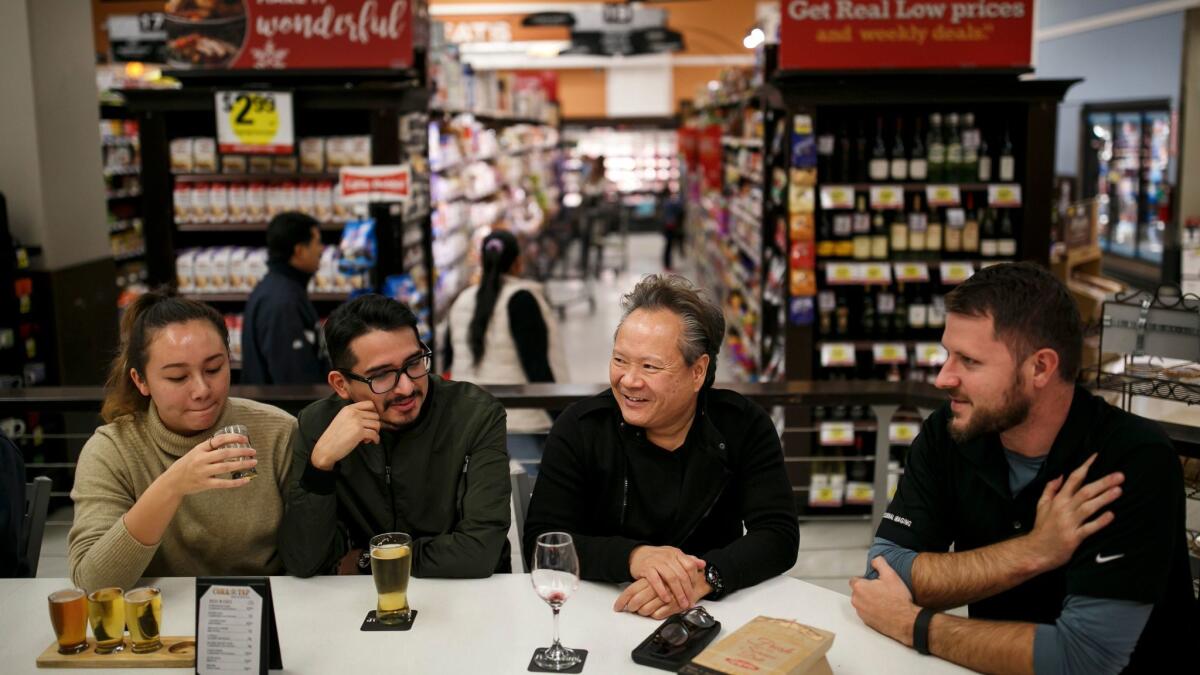 Carolyne Green, Allan Reyes, Jerry Wong and Eric Holm socialize at a bar inside the Ralphs grocery store in downtown L.A.