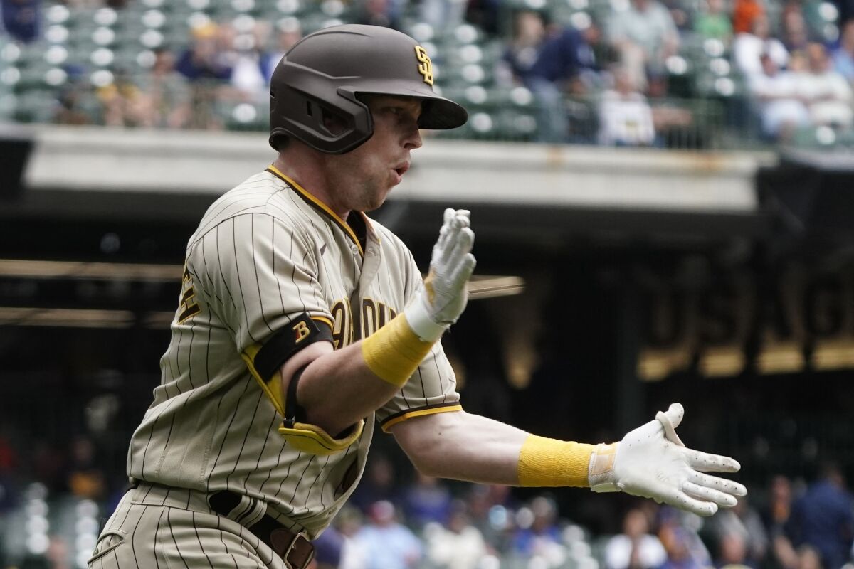 Padres' Jake Cronenworth reacts after hitting a three-run home run during the 10th inning Sunday in Milwaukee.