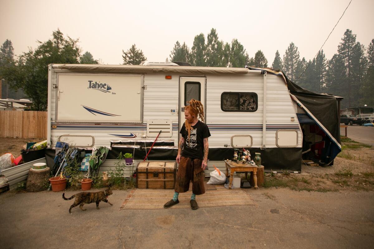 Ben Skeleton stands outside of his camper in South Lake Tahoe as firefighters tackling the Caldor Fire.