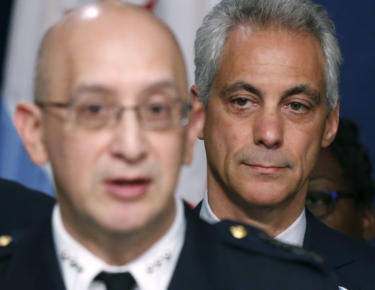 Chicago Mayor Rahm Emanuel, right, listens to interim Police Supt. John Escalante during a news conference about new police procedures Wednesday. Emanuel says every Chicago police patrol car will be equipped with a Taser.