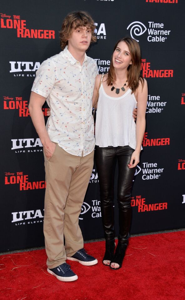 Actress Emma Roberts (L) and Evan Peters arrive at the premiere of Walt Disney Pictures' "The Lone Ranger."