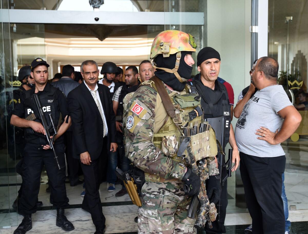 Tunisian security forces stand in front of the Imperial hotel in the resort town of Sousse, a popular tourist destination 90 miles south of the Tunisian capital on June 26.