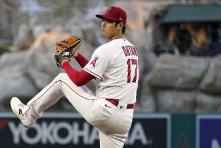 Angels pitcher Shohei Ohtani winds up to throws from the mound 