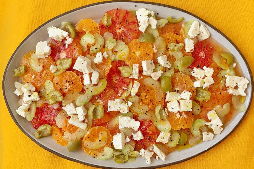 Seasonal Cook-- cold and salty orange salad. This is a salad of sweet orange citrus marinated in a salty-things vinaigrette made with feta, grated celery, anchovies, salt-cured olives, and capers.