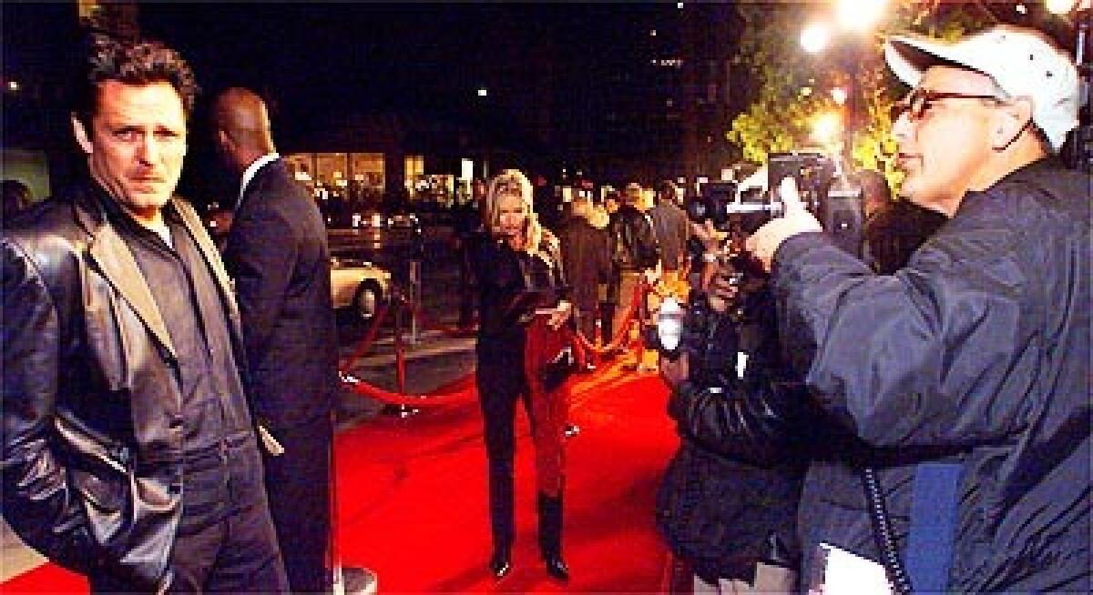 Celebrity photographer Jim Smeal on the red carpet photographing celebrity Michael Madsen at a screening in Beverly Hills.