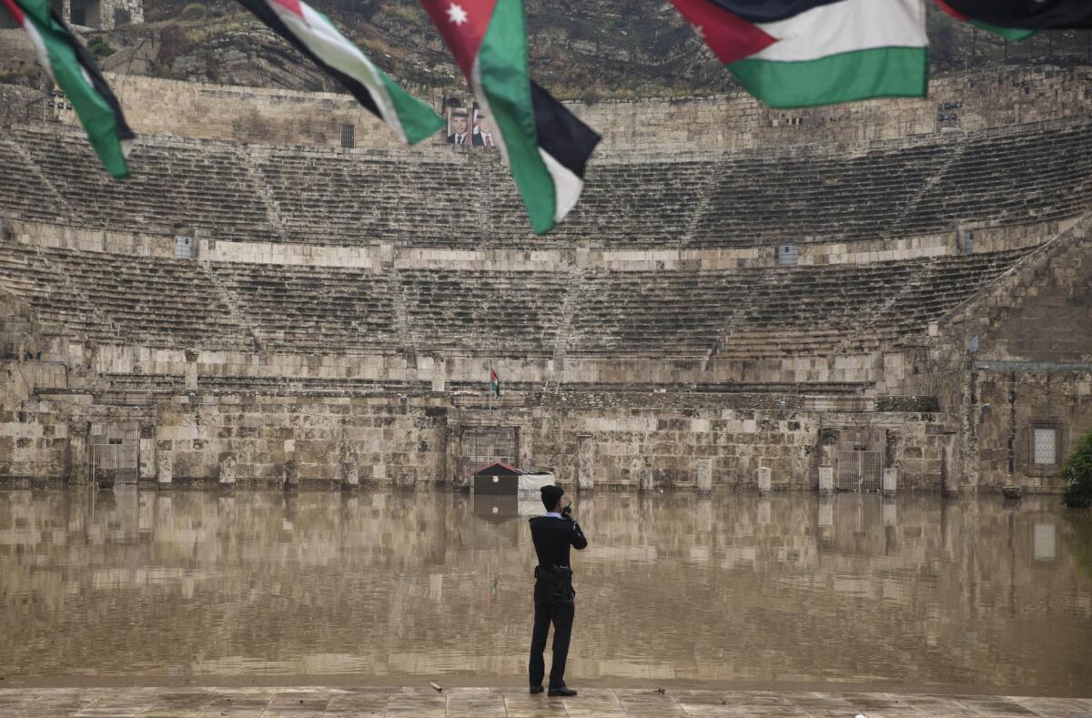 A policeman inspects the flooded ancient Roman theater in downtown Amman, Jordan, on Nov. 5.