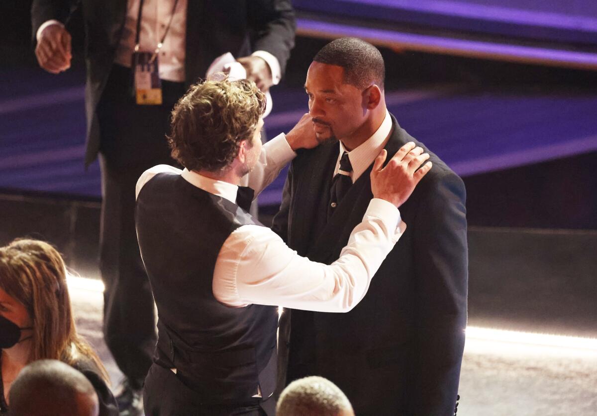 Bradley Cooper comforts Will Smith during the show at the 94th Academy Awards.