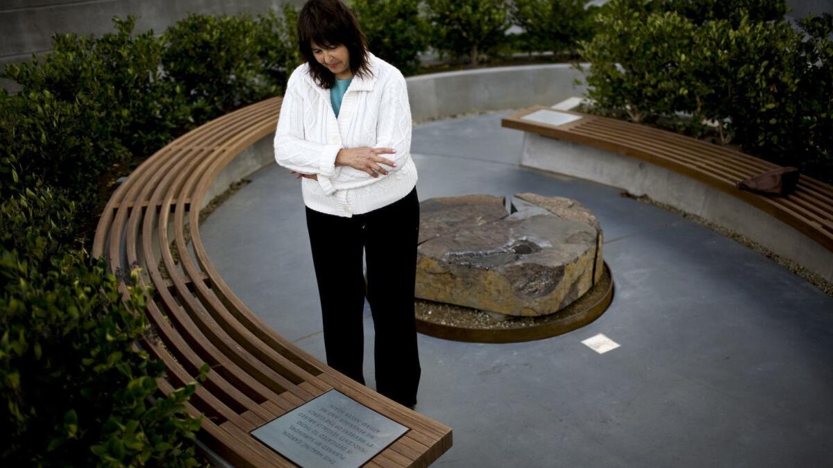 Terrie Light, a victim of clergy abuse, examines the Healing Garden memorial she lobbied for during construction of the Cathedral of Christ the Light in Oakland.