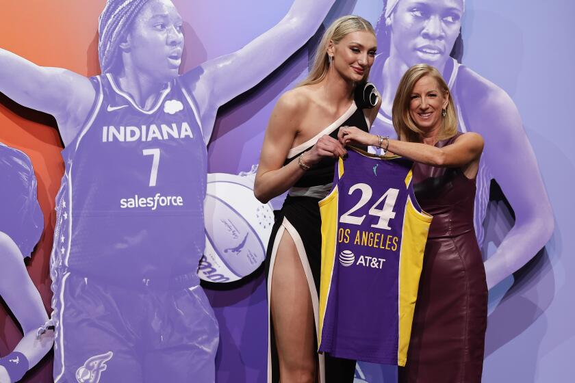 Stanford's Cameron Brink, left, poses for a photo with WNBA commissioner Cathy Engelbert after being selected second over by the Los Angeles Sparks during the first round of the WNBA basketball draft, Monday, April 15, 2024, in New York. (AP Photo/Adam Hunger)