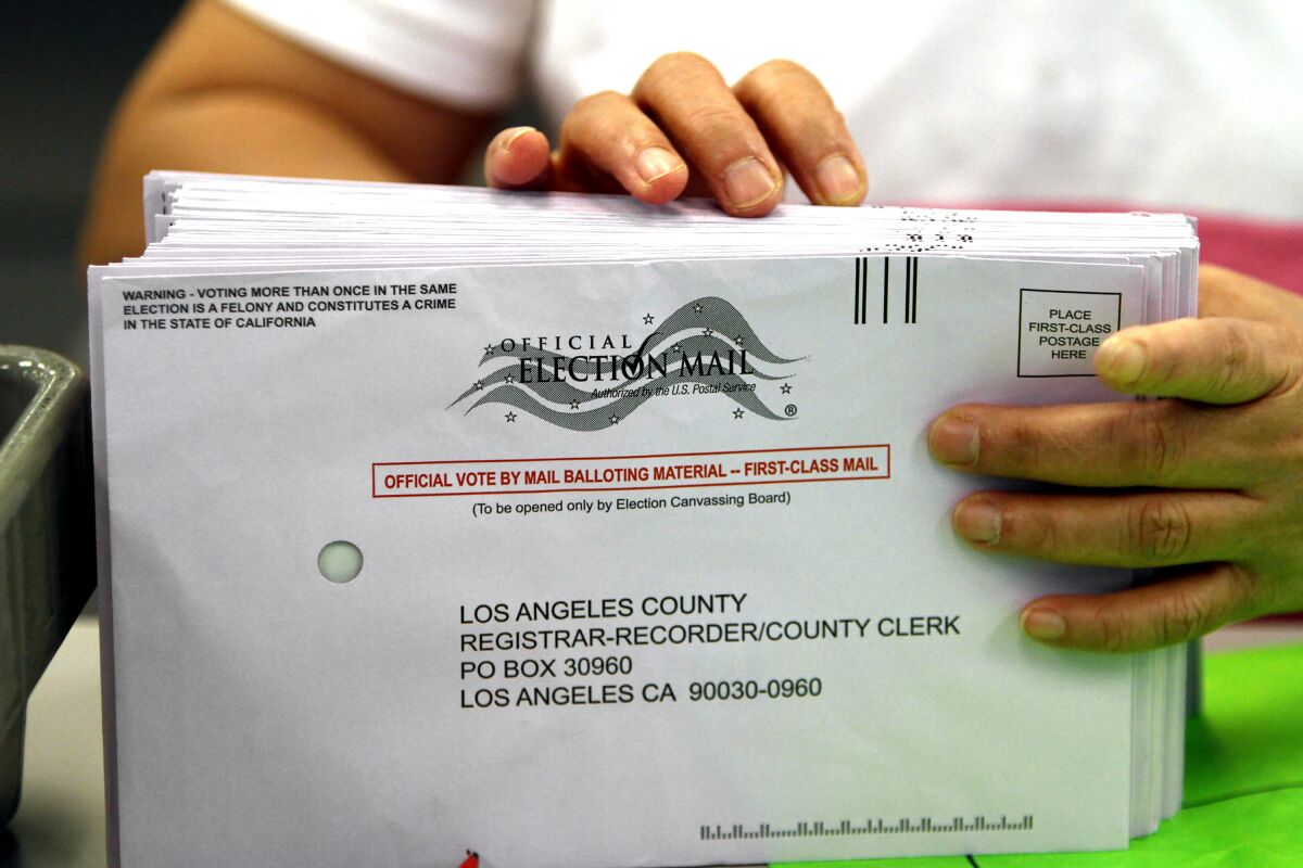 A clerk sorts mail-in ballots at the Los Angeles County Registrar's office in Norwalk.