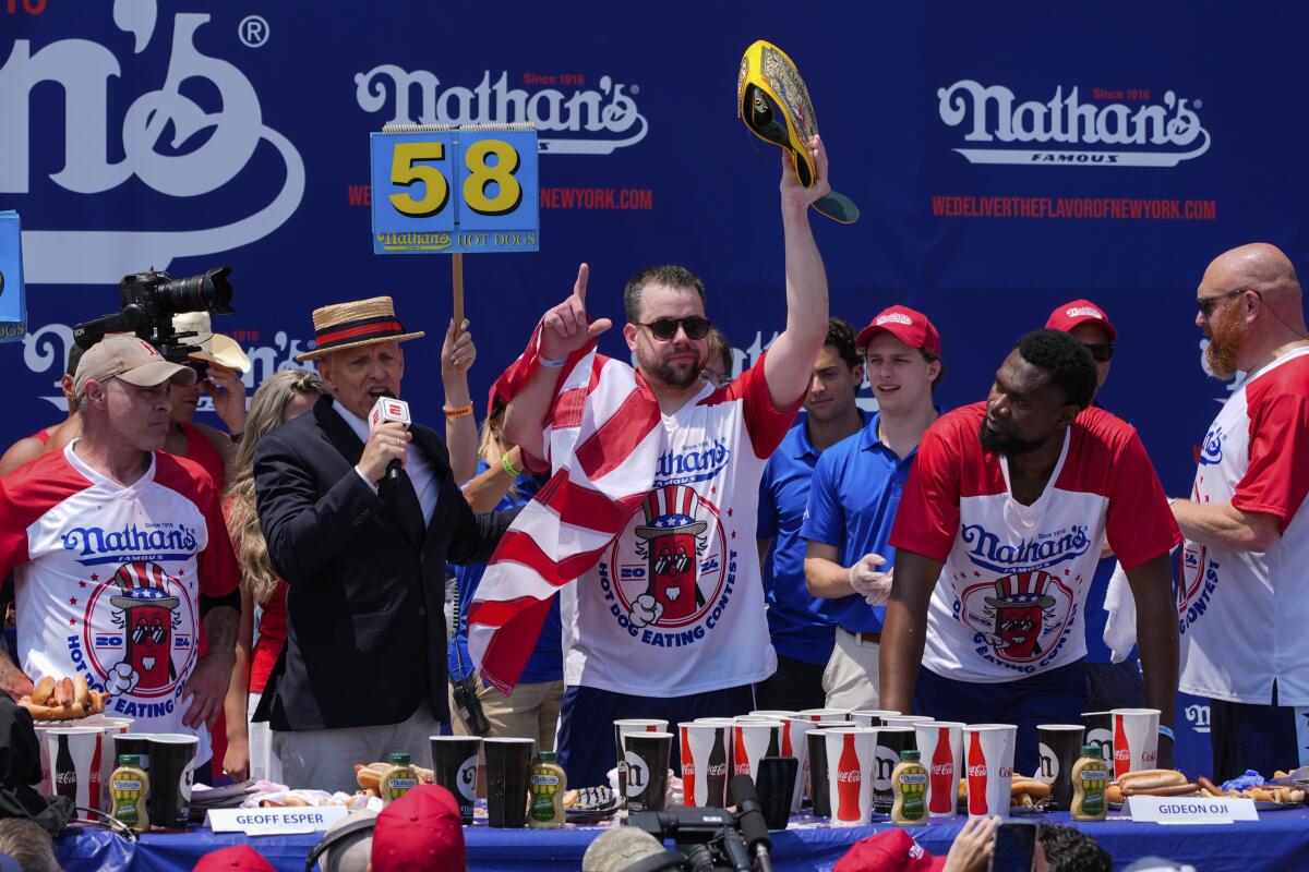 Patrick Bertoletti celebrates after winning the men's division of Nathan's Famous Fourth of July hot dog eating contest 
