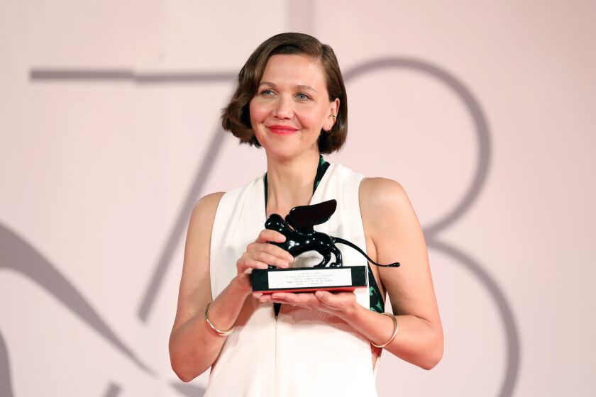 VENICE, ITALY - SEPTEMBER 11: Maggie Gyllenhaal poses with the Award for Best Screenplay for "The Lost Daughter" at the awards winner photocall during the 78th Venice International Film Festival on September 11, 2021 in Venice, Italy. (Photo by Marc Piasecki/Getty Images)