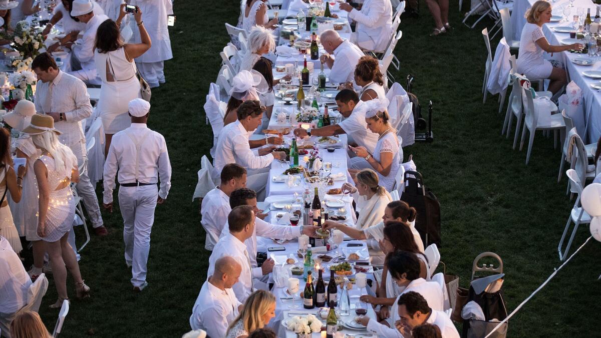 Thousands of people attend this year's Diner en Blanc pop-up dinner in New York City. The Los Angeles Diner en Blanc is scheduled for November.