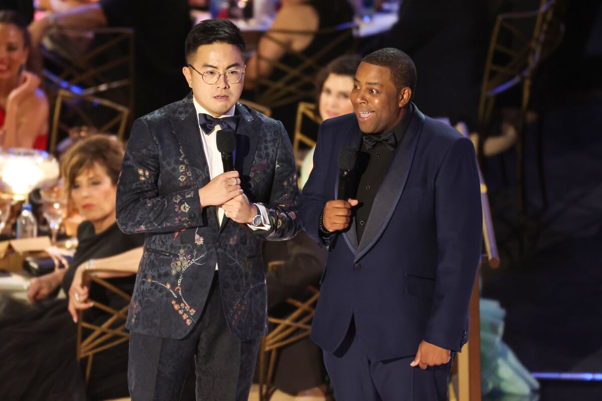 Bowen Yang and host Kenan Thompson onstage during the 74th Primetime Emmys.