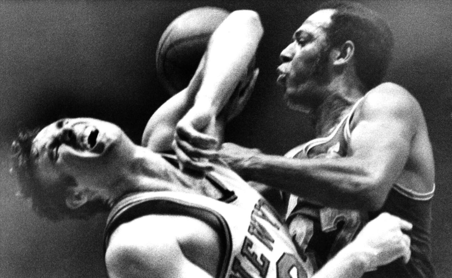 New York Knicks' Dave DeBusschere winces as he and the Los Angeles Lakers' Elgin Baylor collide in the first period of a game at New York’s Madison Square Garden on April 24, 1970.