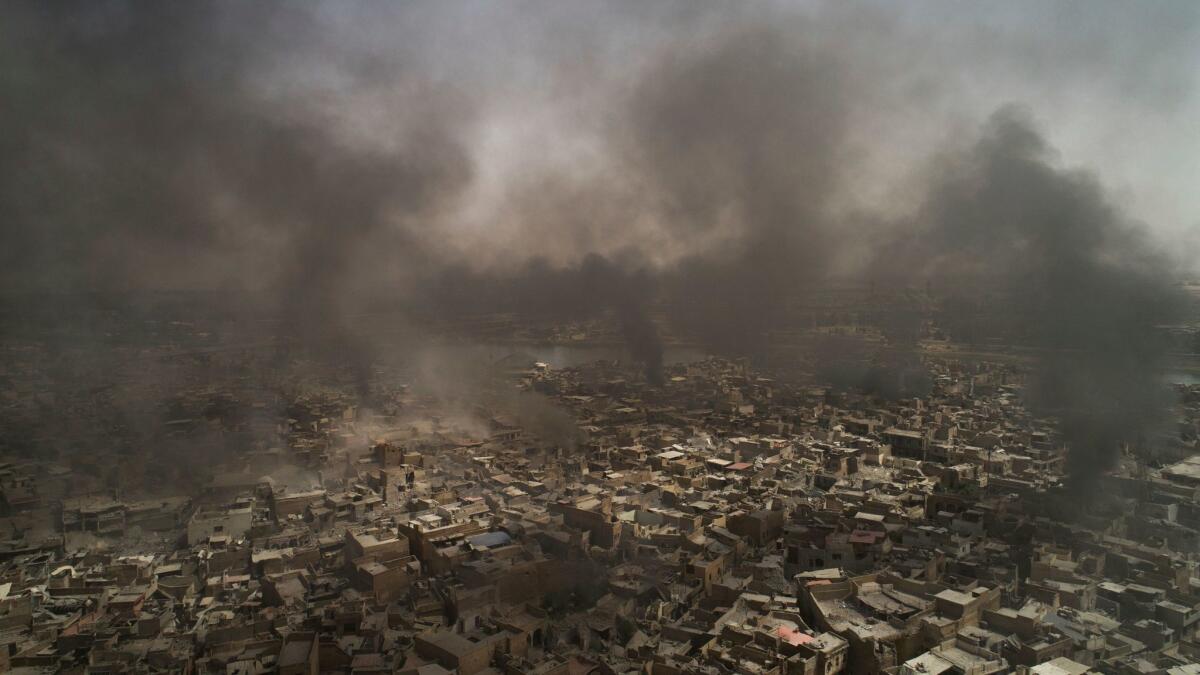 Smoke billows over the Old City neighborhood as Iraqi forces continue their advance against Islamic State militants in Mosul on July 3.