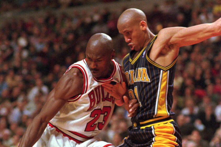 Chicago Bulls' Michael Jordan (23) loses control of the ball while being guarded by Indiana Pacers' Reggie Miller (31) during the second half Tuesday, Feb. 17, 1998, in Chicago. The Bulls defeated the Pacers 105–97. (AP Photo/Fred Jewell)