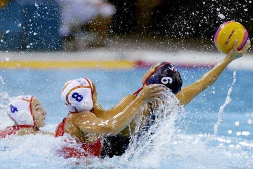 Maggie Steffens of the United States, right, is challenged by Pilar Pena Carrasco of Spain during their women's water polo preliminary-round match Wednesday.