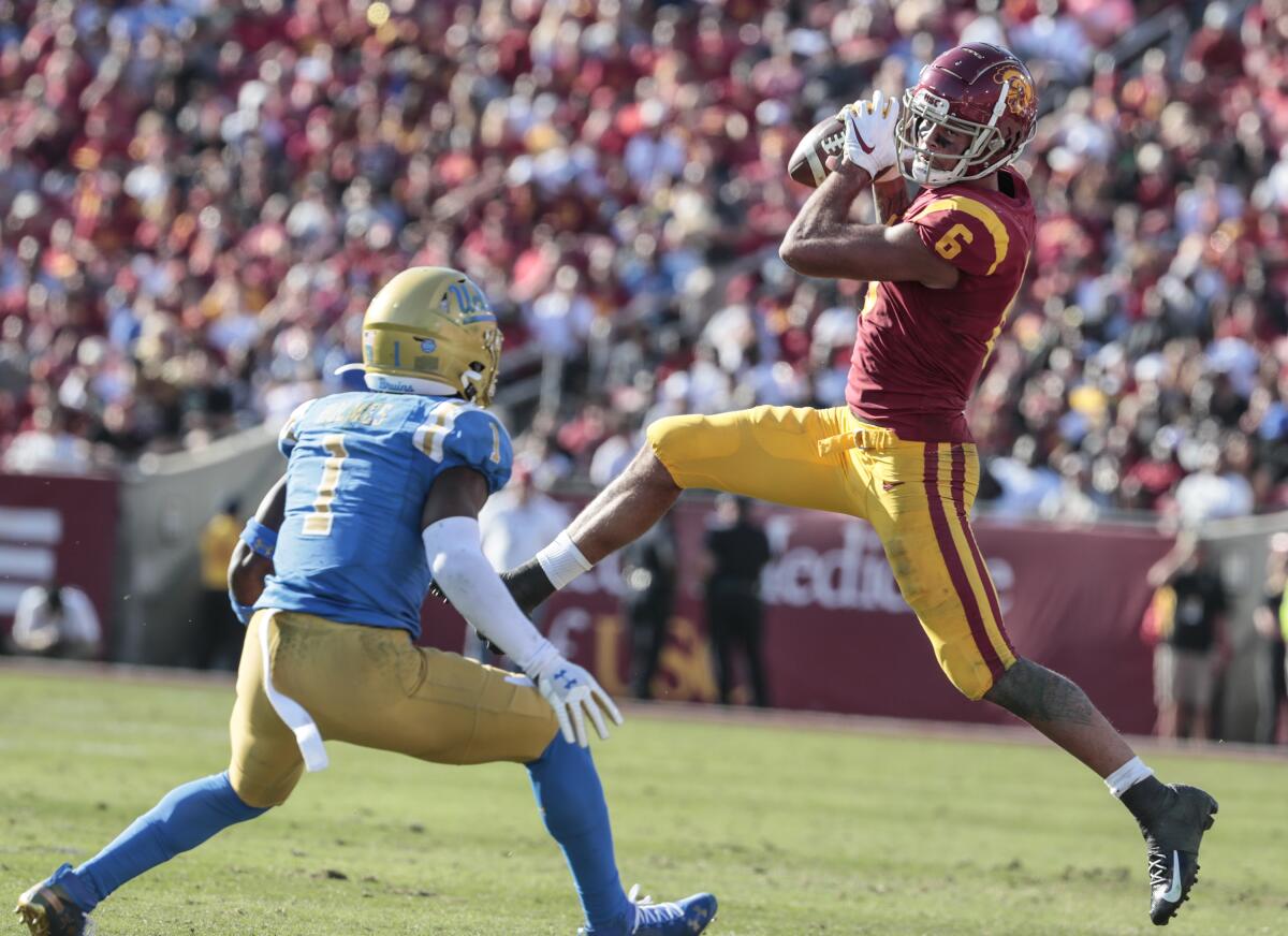 USC wide receiver Michael Pittman Jr. catches a pass in front of UCLA defensive back Darnay Holmes at the Coliseum on Saturday.