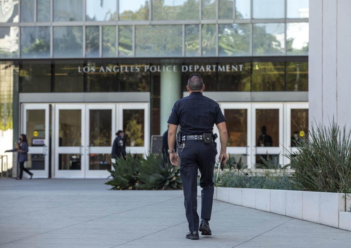 An LAPD officer walks toward department headquarters in downtown Los Angeles on Oct. 14. 