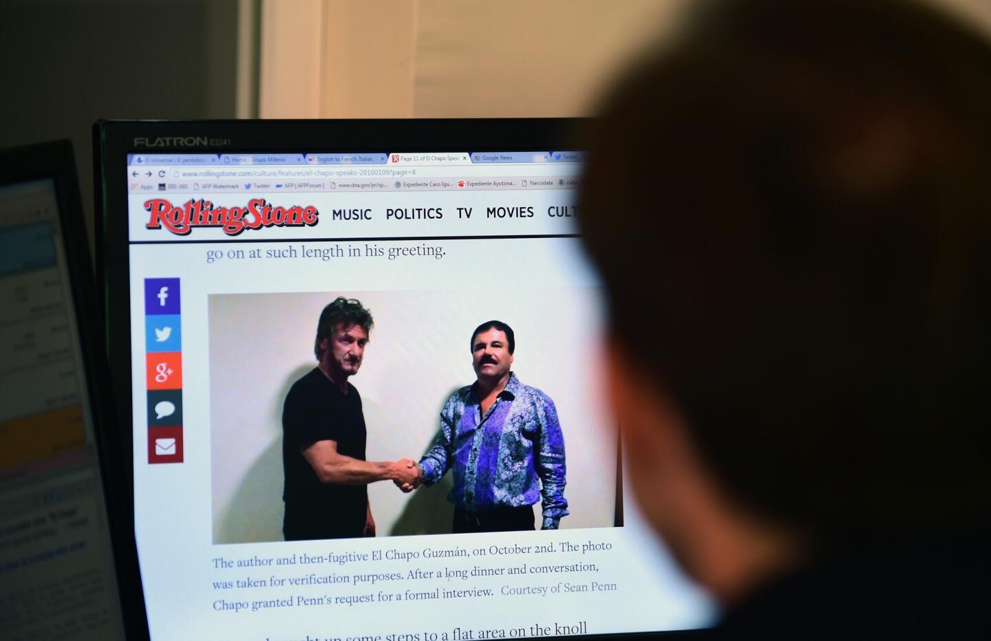 A man reads an article about drug lord Joaquin "El Chapo" Guzman showing a picture of him and actor Sean Penn on the website of Rolling Stone magazine in Mexico City on Jan. 10, 2016.