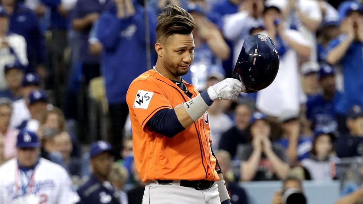 Astros first baseman Yuli Gurriel tips his helmet toward Dodgers pitcher Yu Darvish before getting into the batter's box during the first inning of Game 7.