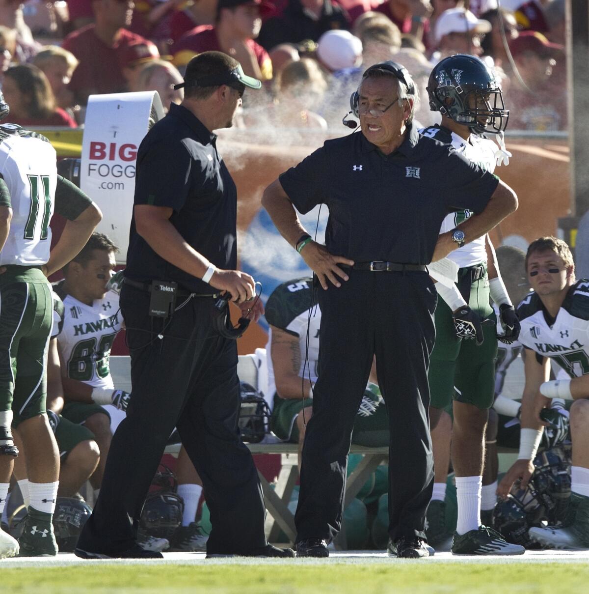 Hawaii football coach Norm Chow, center, has dismissed offensive coordinator Aaron Price.