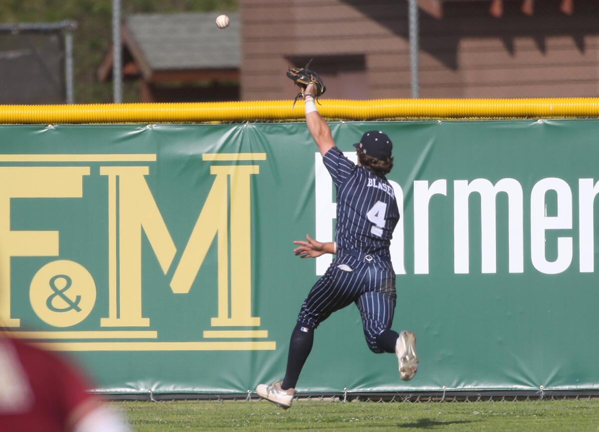 Newport Harbor's Bryce Blaser (4) can't get to a double to center field by Oaks Christian's Thomas Farmer on Tuesday.