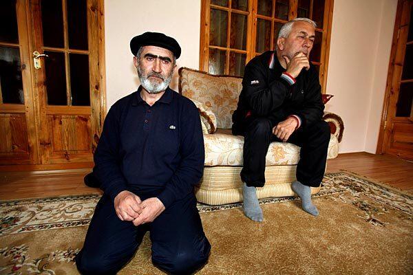 Rasul Magomedov, left, sits with a relative in his home in the village of Balakhani in Dagestan. His daughter, Mariyam Sharipova, is believed to be the suicide bomber who attacked the Lubyanka subway station last month in downtown Moscow. See full story