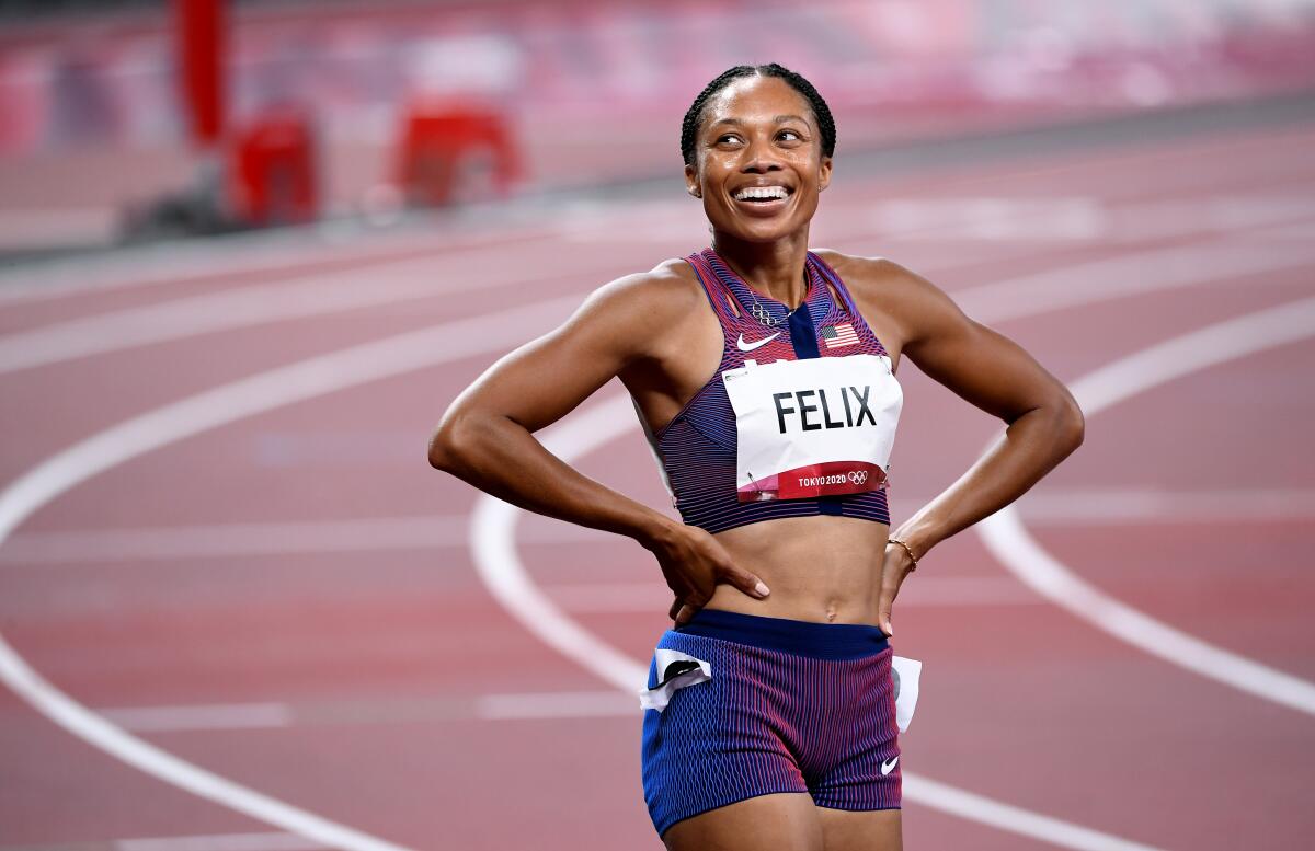 USA's Allyson Felix smiles after winning the bronze medal in the 400m race at the 2020 Tokyo Olympics.