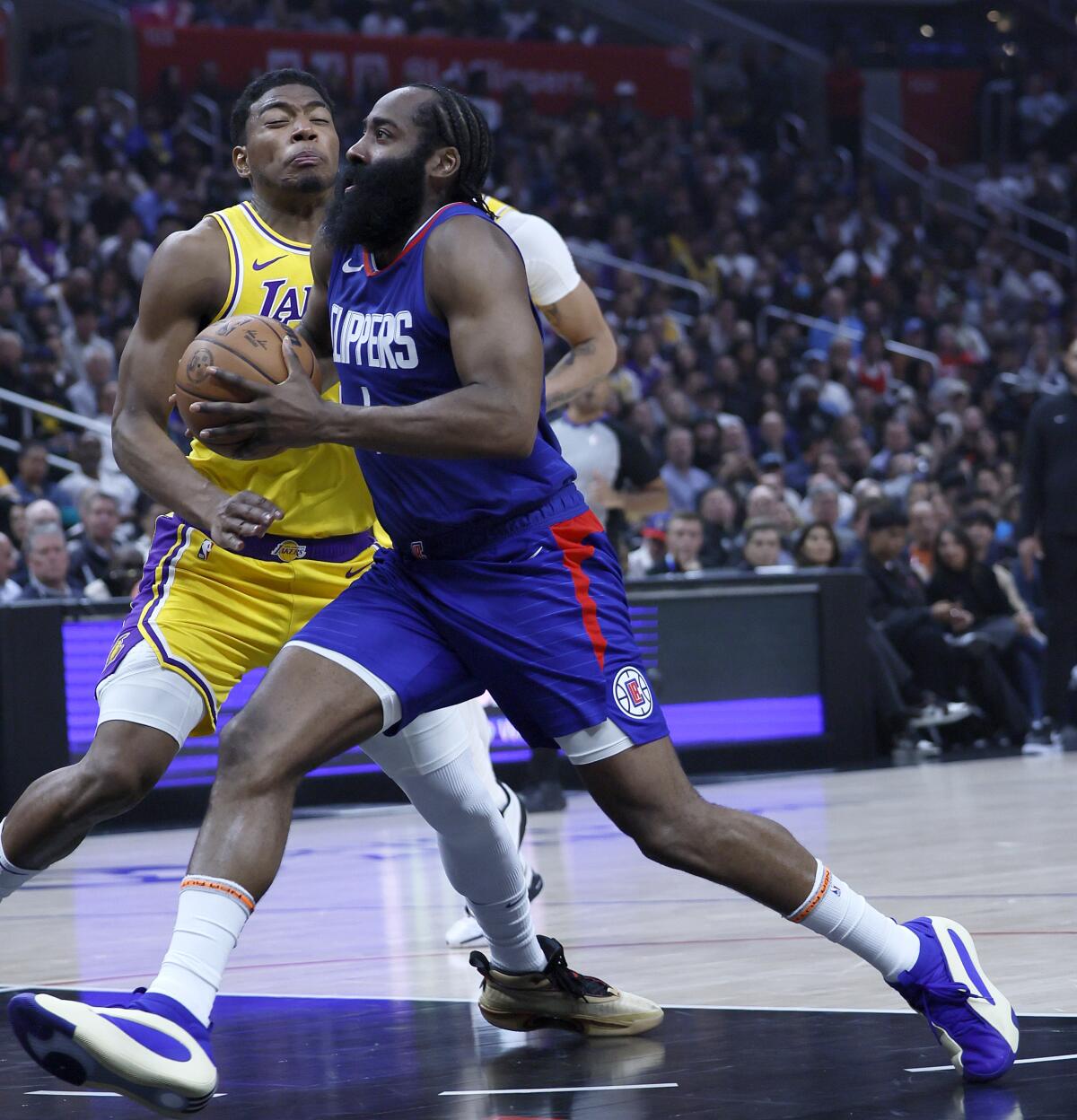 Clippers guard James Harden drives past Lakers forward Rui Hachimura during the first half of Tuesday's game.