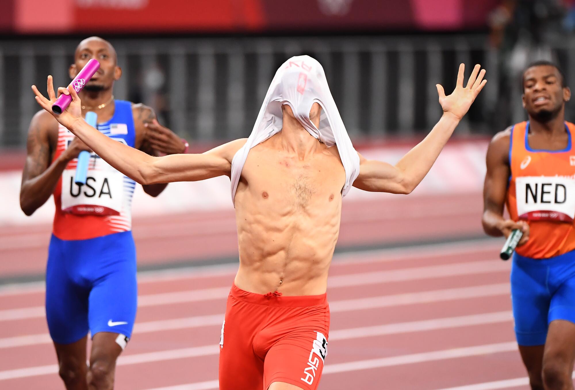 Kajetan Duszynski crosses the finish line first for team Poland to capture the 4X400 relay mixed race.