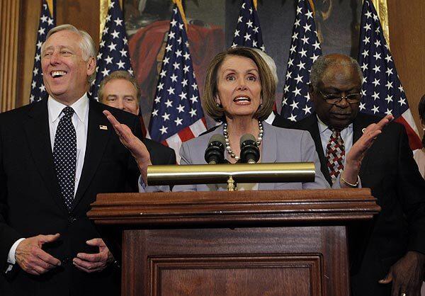 House Speaker Nancy Pelosi, with other Democrats, addresses the media after the House passed the healthcare bill.