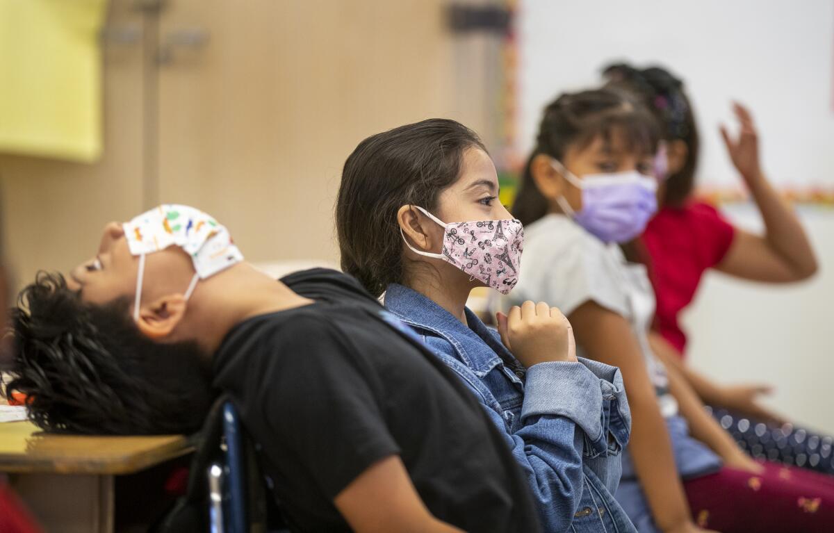 Elementary school children wearing masks