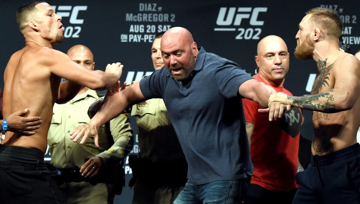 UFC President Dana White separates Nate Diaz, left, and Conor McGregor at the weigh-in for UFC 202 on Friday.