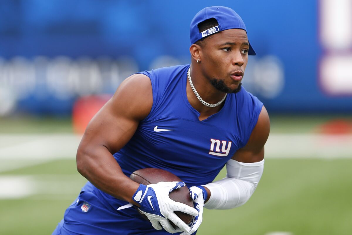New York Giants running back Saquon Barkley warms up before a preseason game against the New England Patriots.