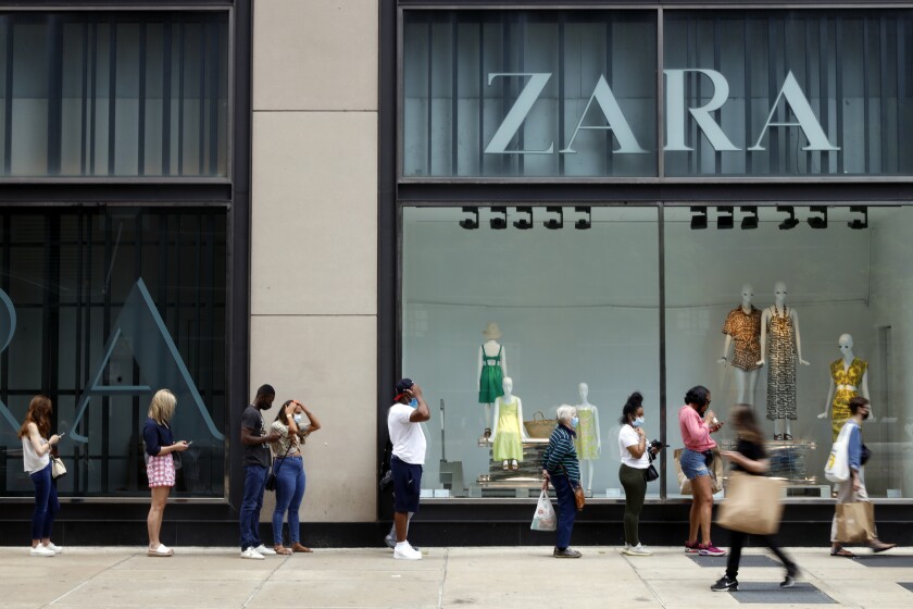 Shoppers line up outside a Zara clothing store in Chicago 