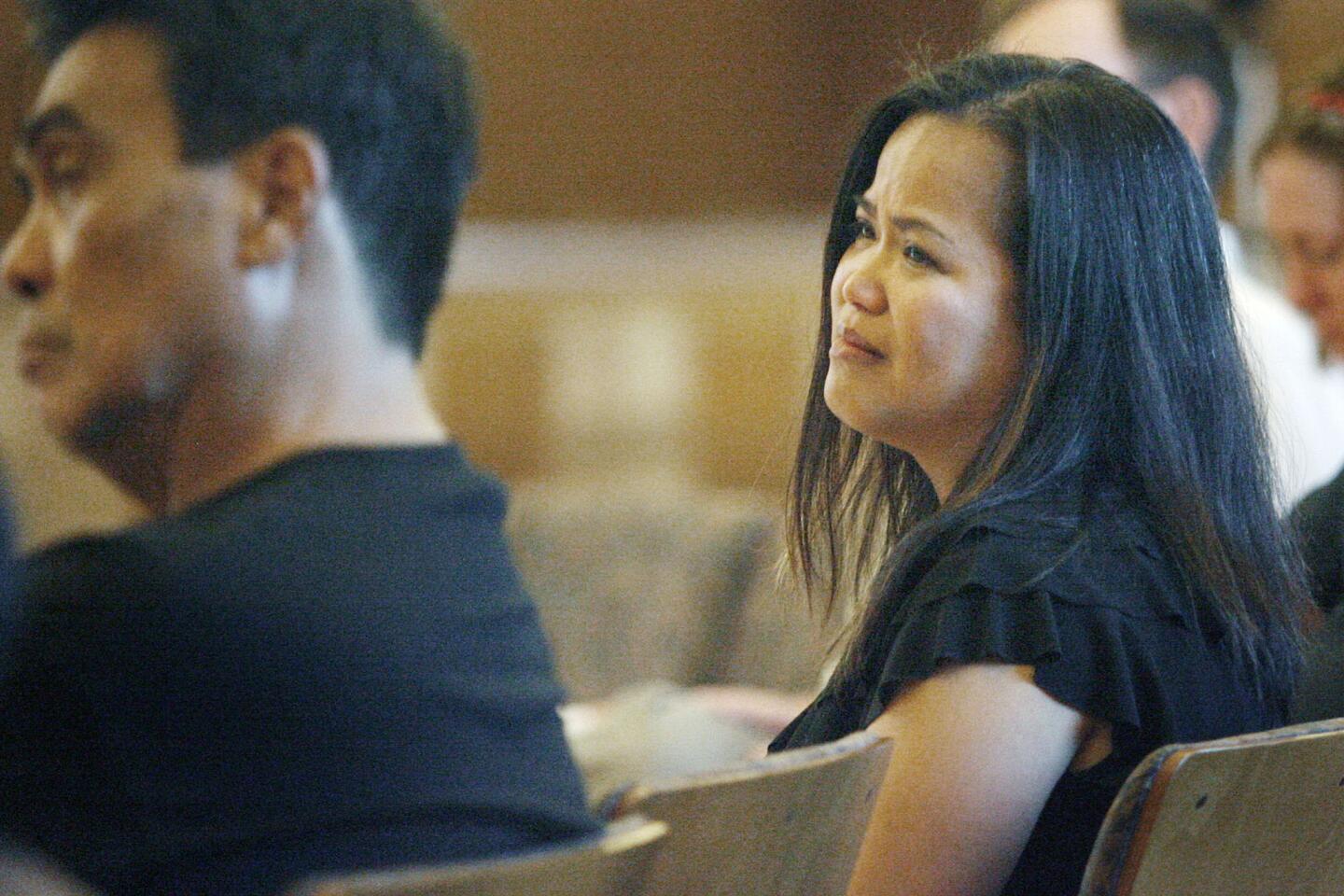 Thea Ivens, right, listens to Jaime Gonzalez read his eulogy during a vigil for Thea's husband, FBI agent Stephen Ivens, which took place at St. Franci Xavier Catholic Church in Burbank on Thursday, August 9, 2012.