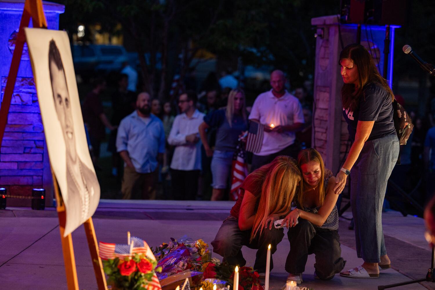 A young woman cries during a candlelight vigil for youth activist and influencer Charlie Kirk at a makeshift memorial at Orem City Center Park in Orem, Utah, a day after he was shot during a public event at Utah Valley University on September 11, 2025. The gunman who shot dead US right-wing youth leader Charlie Kirk in a targeted killing remained at large Thursday but authorities said they have video images of the suspect and have recovered a