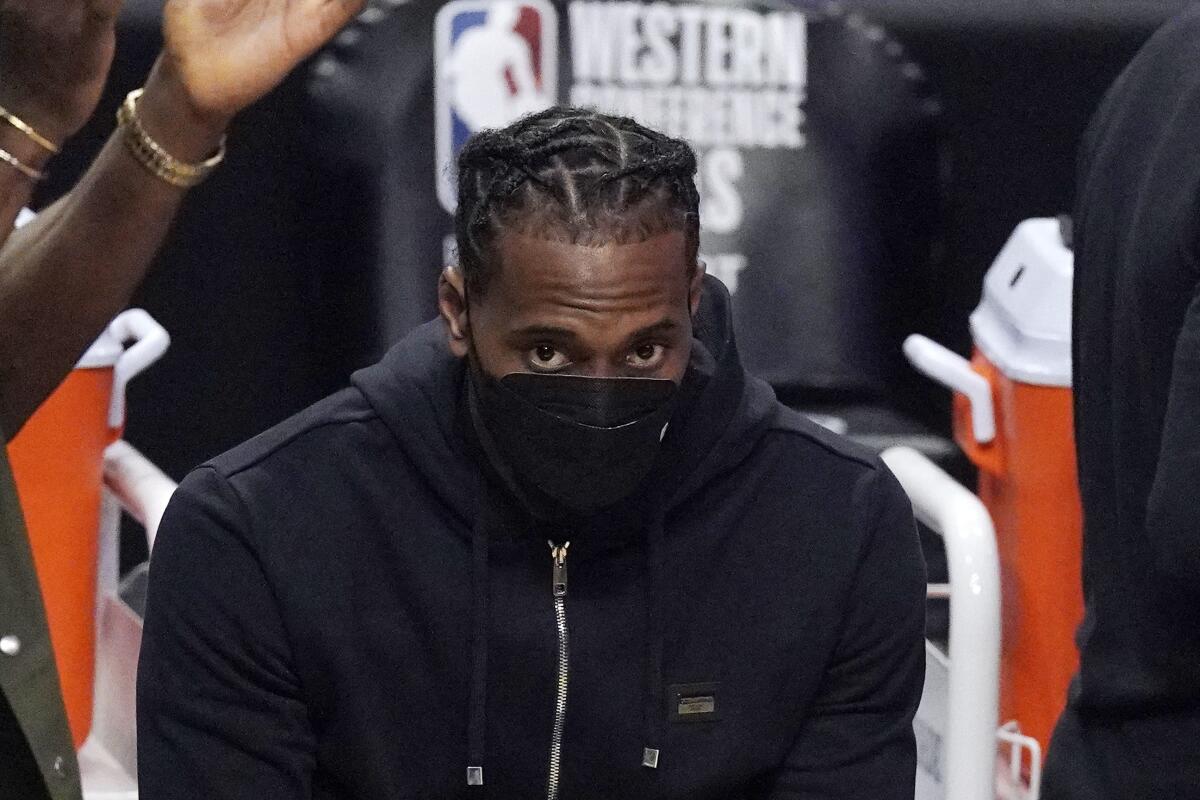 Los Angeles Clippers forward Kawhi Leonard sits on the bench during the first half in Game 6 of the NBA basketball Western Conference Finals against the Phoenix Suns Wednesday, June 30, 2021, in Los Angeles. (AP Photo/Mark J. Terrill)