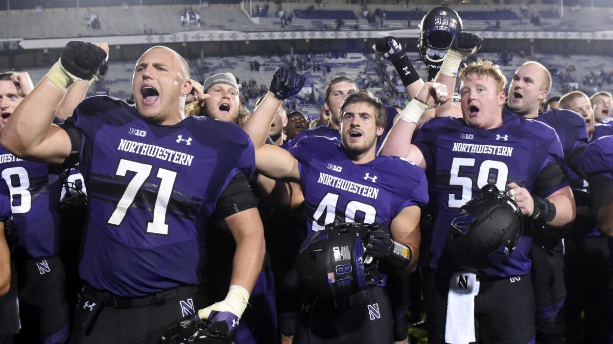Northwestern football players celebrate after beating Duke during a nonconference game on Sept. 17.