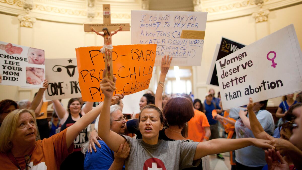 Opponents and supporters of abortion rights gather in the State Capitol rotunda in Austin, Texas in July of 2013, after the state Senate approved tight restrictions on abortion.