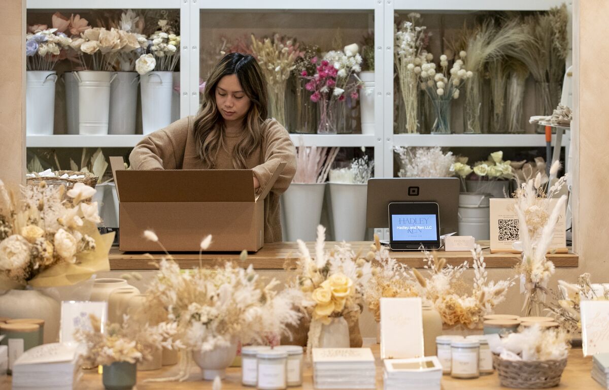 Cynthia Tran packages an order for a customer at Hadley & Ren Floral Co.